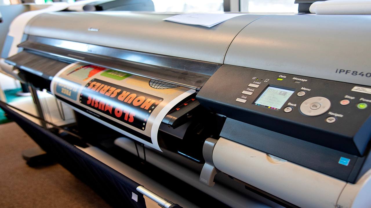 Cal Poly students collaborating at a table with printed materials.